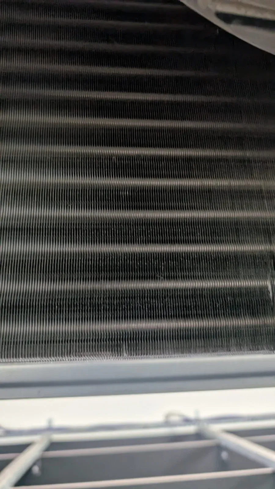 Exposed air conditioning coil during a service inspection